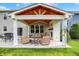 Inviting covered patio with a fireplace, comfortable seating, and a wood-beamed ceiling at 848 Silverheels Dr, Westfield, IN 46074