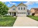 Charming two-story home with a stone facade, well-manicured lawn, and an inviting front entrance at 848 Silverheels Dr, Westfield, IN 46074