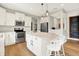 Modern kitchen with white cabinetry, stainless steel appliances, and a kitchen island with bar stools at 848 Silverheels Dr, Westfield, IN 46074