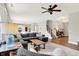 Bright, open living room with hardwood floors, a large sectional sofa, and a view of the kitchen at 848 Silverheels Dr, Westfield, IN 46074