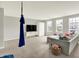 Open-concept living area with large windows, a comfortable sofa, and unique aerial swing at 848 Silverheels Dr, Westfield, IN 46074