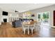 Open-concept living area with a dining table, comfortable seating, and backyard access at 848 Silverheels Dr, Westfield, IN 46074