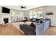 Comfortable living room showcasing a fireplace, hardwood floors, and a sectional sofa with backyard views at 848 Silverheels Dr, Westfield, IN 46074