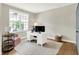 Bright home office with a white desk, comfortable seating, and a large window offering natural light at 848 Silverheels Dr, Westfield, IN 46074