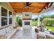 Cozy outdoor patio featuring a fireplace, comfortable seating, ceiling fan, and wooden ceiling at 848 Silverheels Dr, Westfield, IN 46074