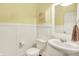Stylish powder room with modern fixtures, wainscoting, and decorative art; perfect for guests at 848 Silverheels Dr, Westfield, IN 46074