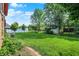 Lush backyard garden with mature trees offers a serene retreat in this meticulously landscaped outdoor space at 8619 Wrangler Ct, Indianapolis, IN 46217