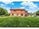 A manicured lawn surrounds the home's brick and siding exterior with screened in porch, offering outdoor relaxation at 8619 Wrangler Ct, Indianapolis, IN 46217
