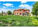 Expansive green backyard featuring lush grass and mature landscaping, ideal for outdoor activities and serene views at 8619 Wrangler Ct, Indianapolis, IN 46217