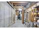 Unfinished basement with water heater and various utility connections, and storage options at 8619 Wrangler Ct, Indianapolis, IN 46217