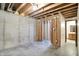 Unfinished basement features concrete walls and exposed wood framing; bathroom is partially visible at 8619 Wrangler Ct, Indianapolis, IN 46217