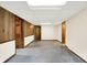 Wide-angle view of a large, open basement with paneled wall and drop ceiling at 8619 Wrangler Ct, Indianapolis, IN 46217