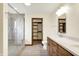 Bathroom featuring a shower, double sinks, updated lighting, and a walk-in closet at 8619 Wrangler Ct, Indianapolis, IN 46217