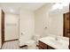White bathroom features a modern vanity, mirror, toilet, and open shower at 8619 Wrangler Ct, Indianapolis, IN 46217