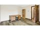 Bedroom featuring a bookshelf, a desk, a door to another room, and light colored walls at 8619 Wrangler Ct, Indianapolis, IN 46217
