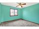 Bedroom with a window, ceiling fan, and plush carpet at 8619 Wrangler Ct, Indianapolis, IN 46217
