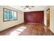 Bedroom featuring hardwood floors, a window, an accent wall, and light colored walls at 8619 Wrangler Ct, Indianapolis, IN 46217