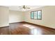 Bedroom featuring hardwood floors, a ceiling fan, a window, and light colored walls at 8619 Wrangler Ct, Indianapolis, IN 46217