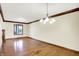 Formal dining room featuring hardwood floors, trim, and a chandelier at 8619 Wrangler Ct, Indianapolis, IN 46217