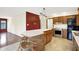 Open kitchen features a large island with seating, stainless steel oven, and black refrigerator at 8619 Wrangler Ct, Indianapolis, IN 46217