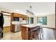 Well-equipped kitchen featuring wooden cabinets, island with seating, and stainless steel appliances at 8619 Wrangler Ct, Indianapolis, IN 46217