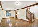 Bright living room with hardwood floors, large window, and decorative trim at 8619 Wrangler Ct, Indianapolis, IN 46217