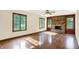 Bright living room showcasing a classic brick fireplace with large windows overlooking yard at 8619 Wrangler Ct, Indianapolis, IN 46217