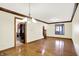 Open living room with hardwood floors, decorative trim, and a view of the kitchen at 8619 Wrangler Ct, Indianapolis, IN 46217