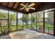 Relaxing screened porch with wood flooring and views of the backyard and mature trees at 8619 Wrangler Ct, Indianapolis, IN 46217