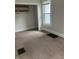Cozy bedroom with plush carpeting, closet, and window, perfect for relaxation at 88 N 15Th Ave, Beech Grove, IN 46107