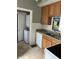 Efficient kitchen with granite countertops, tile backsplash, and adjacent laundry area at 88 N 15Th Ave, Beech Grove, IN 46107