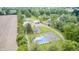 Aerial perspective showcasing the estate with the main house, outbuildings, pond, and a swimming pool at 8879 W County Road 700 S, Coatesville, IN 46121