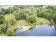Drone shot featuring the lake and a shady area with dock at 8879 W County Road 700 S, Coatesville, IN 46121