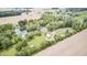 Gorgeous aerial view showcasing a pond, home, pool, outbuildings, and land at 8879 W County Road 700 S, Coatesville, IN 46121