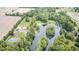 Aerial view of the property featuring a pond, mature trees, home, and a pool at 8879 W County Road 700 S, Coatesville, IN 46121