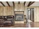 Inviting living room featuring a fireplace, hardwood floors, and a comfortable brown leather sofa at 8879 W County Road 700 S, Coatesville, IN 46121