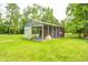 Enclosed outbuilding or shed with wire mesh, offering functional outdoor space on a grassy lot at 8879 W County Road 700 S, Coatesville, IN 46121
