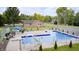 Aerial view of a fenced outdoor swimming pool with a diving board, slide, and patio furniture at 8879 W County Road 700 S, Coatesville, IN 46121