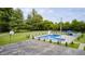 Aerial shot of a fenced pool with diving board and slide, alongside a basketball court and outdoor tent at 8879 W County Road 700 S, Coatesville, IN 46121