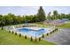 Aerial view of an outdoor pool with slide and blue trim, surrounded by well-maintained landscaping at 8879 W County Road 700 S, Coatesville, IN 46121