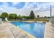 Backyard pool with a slide, mature trees, patio seating, and an enclosure for privacy at 8879 W County Road 700 S, Coatesville, IN 46121