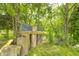 Unique treehouse structure built around large tree trunks, nestled in a serene wooded setting at 8879 W County Road 700 S, Coatesville, IN 46121