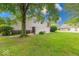 Expansive backyard featuring a well-kept lawn, mature trees, and a charming patio area at 9054 Cornucopia Dr, Indianapolis, IN 46268