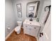 Powder room featuring a modern vanity, decorative mirror, and views of the laundry room at 9054 Cornucopia Dr, Indianapolis, IN 46268