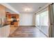 Bright dining area with wood floors, stainless appliances, and sliding door to outdoor space at 9054 Cornucopia Dr, Indianapolis, IN 46268
