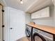 Convenient laundry room with modern appliances, butcher block countertop, and ample storage at 9054 Cornucopia Dr, Indianapolis, IN 46268