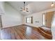 Vaulted ceiling, wood-look floors, a modern ceiling fan, and large windows illuminate the living room at 9054 Cornucopia Dr, Indianapolis, IN 46268