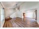 Open living space with wood-look floors, vaulted ceiling, and modern lighting at 9054 Cornucopia Dr, Indianapolis, IN 46268