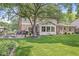 Beautiful backyard with a patio, lush lawn, and sunroom, providing a perfect blend of indoor and outdoor living at 9221 Holyoke Ct, Indianapolis, IN 46268