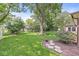 Lush backyard showcasing mature trees, a well-maintained lawn, and beautiful landscaping, creating a peaceful outdoor retreat at 9221 Holyoke Ct, Indianapolis, IN 46268